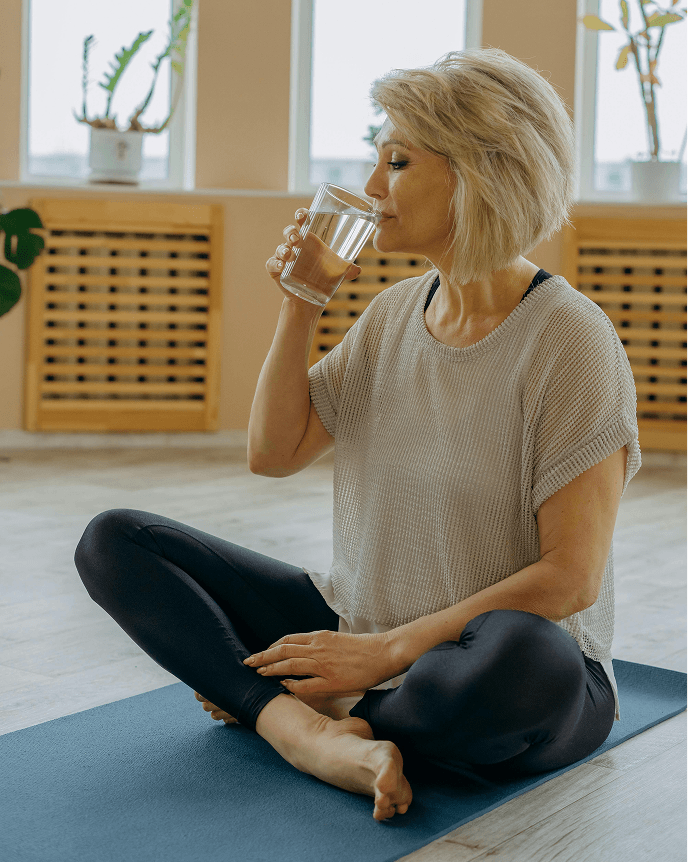 A mature woman drinking water